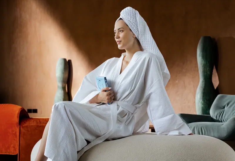 Guest relaxing in a white robe